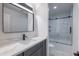 Modern bathroom features a vanity with stone top and a sliding door shower at 5109 W Sanna St, Glendale, AZ 85302