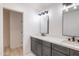 Bathroom featuring double sinks, modern fixtures, and grey cabinetry at 5109 W Sanna St, Glendale, AZ 85302