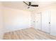 Bright bedroom featuring modern closet, ceiling fan and wood-look flooring at 5109 W Sanna St, Glendale, AZ 85302