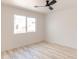 Empty bedroom with light wood floors, a window overlooking greenery, and white walls at 5109 W Sanna St, Glendale, AZ 85302