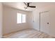 Bright bedroom with modern ceiling fan, closet and window at 5109 W Sanna St, Glendale, AZ 85302