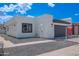 Charming home with stucco exterior, dark garage door, and desert landscaping for low maintenance at 5109 W Sanna St, Glendale, AZ 85302