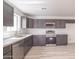 The modern kitchen features gray cabinets, white counters, and stainless steel appliances at 5109 W Sanna St, Glendale, AZ 85302