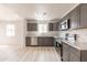 Modern kitchen features grey cabinetry, stainless steel appliances, and white countertops at 5109 W Sanna St, Glendale, AZ 85302