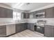 Modern kitchen featuring dark cabinets, white countertops, and stainless steel appliances at 5109 W Sanna St, Glendale, AZ 85302