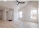 Open-concept living room with vaulted ceilings, a modern ceiling fan, and multiple windows at 5109 W Sanna St, Glendale, AZ 85302