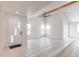 Sunlit living room featuring vaulted ceilings, a ceiling fan, and a modern, decorative front door at 5109 W Sanna St, Glendale, AZ 85302