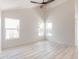 Sunlit living room features vaulted ceilings, modern ceiling fan, and multiple windows at 5109 W Sanna St, Glendale, AZ 85302