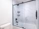 A modern, glass shower with marble tiling, matte black hardware, and storage niches at 5109 W Sanna St, Glendale, AZ 85302