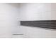 Close up of a shower featuring modern white tile with decorative black accent at 5109 W Sanna St, Glendale, AZ 85302