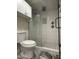 Modern bathroom featuring glass shower with mosaic tile flooring, and rain shower fixtures at 5132 N 31St Way # 123, Phoenix, AZ 85016