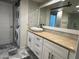 Stylish bathroom with unique vessel sink, stone countertops, and stackable washer and dryer at 5132 N 31St Way # 123, Phoenix, AZ 85016