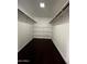 Spacious walk-in closet with shelving and dark wood-style floor at 5132 N 31St Way # 123, Phoenix, AZ 85016