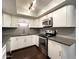 Modern kitchen featuring stainless steel appliances, white cabinetry, and sleek countertops for a stylish cooking experience at 5132 N 31St Way # 123, Phoenix, AZ 85016