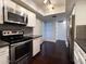 A well-equipped kitchen is accented by elegant lighting, stainless steel appliances, and rich wood flooring, blending style with function at 5132 N 31St Way # 123, Phoenix, AZ 85016