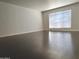 Bright living room featuring new dark wood floors and large window for lots of natural light at 5132 N 31St Way # 123, Phoenix, AZ 85016