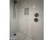 Beautiful tiled shower with a shower head and black and white tile at 5132 N 31St Way # 123, Phoenix, AZ 85016