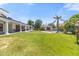 Expansive backyard with lush green lawn, large covered patio, gazebo, and sparkling pool at 521 E Horseshoe Ave, Gilbert, AZ 85296