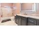 Modern bathroom features a gray vanity, marble countertops, and a well-lit LED mirror at 521 E Horseshoe Ave, Gilbert, AZ 85296