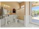Bathroom featuring a shower, white tile floors, and a pedestal sink at 521 E Horseshoe Ave, Gilbert, AZ 85296