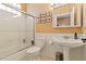 Bright bathroom featuring a shower over tub, white fixtures, and neutral walls at 521 E Horseshoe Ave, Gilbert, AZ 85296