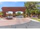 Welcoming community entrance with brick archway, fountain, and lush landscaping at 521 E Horseshoe Ave, Gilbert, AZ 85296