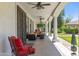 Relaxing covered patio with ornate columns, ceiling fans, and comfortable seating at 521 E Horseshoe Ave, Gilbert, AZ 85296