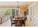 Dining area with a long wooden table, adjacent to the living room, offering great natural light at 521 E Horseshoe Ave, Gilbert, AZ 85296