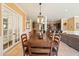 Elegant dining room featuring a large wooden table and a view to the gourmet kitchen at 521 E Horseshoe Ave, Gilbert, AZ 85296