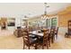 Comfortable dining area featuring a long wooden table and chairs with an open-concept design at 521 E Horseshoe Ave, Gilbert, AZ 85296