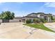Charming home showcasing a large driveway and a three-car garage at 521 E Horseshoe Ave, Gilbert, AZ 85296