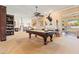 Spacious game room features a pool table, a fireplace, built-in bookcases, and great natural light at 521 E Horseshoe Ave, Gilbert, AZ 85296