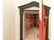 Unique hidden room disguised as a bookshelf with a decorative red door and lion knocker adds mystery to this home at 521 E Horseshoe Ave, Gilbert, AZ 85296