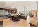 Spacious kitchen boasts dark wood cabinetry, tile flooring, and stainless steel appliances at 521 E Horseshoe Ave, Gilbert, AZ 85296