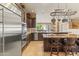 Open kitchen featuring a large island, stainless steel appliances, and dark wood cabinets at 521 E Horseshoe Ave, Gilbert, AZ 85296