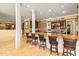 Kitchen island with granite counter top, seating, and a view of the adjoining rooms at 521 E Horseshoe Ave, Gilbert, AZ 85296