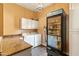 Laundry room with built-in cabinets, granite countertops, and space for a refrigerator at 521 E Horseshoe Ave, Gilbert, AZ 85296