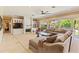 Bright living room features large windows, a fireplace, built-in shelving, and a plush sectional sofa at 521 E Horseshoe Ave, Gilbert, AZ 85296