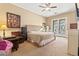 Serene main bedroom with elegant accents, a cozy seating area, and exterior access at 521 E Horseshoe Ave, Gilbert, AZ 85296