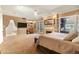Expansive main bedroom boasting a fireplace, built-in shelving, and access to the outside combines style and functionality at 521 E Horseshoe Ave, Gilbert, AZ 85296