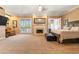Spacious main bedroom featuring a fireplace, sitting area, and French doors to the exterior makes a comfortable retreat at 521 E Horseshoe Ave, Gilbert, AZ 85296