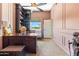 Elegant office with a large wooden desk, built-in bookshelves, and a view from the window to the outdoors at 521 E Horseshoe Ave, Gilbert, AZ 85296