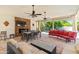 Stylish outdoor living area featuring a stone fireplace, comfortable seating, and an inviting dining space at 521 E Horseshoe Ave, Gilbert, AZ 85296