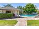 An inviting pool with a rock waterfall feature, complete with an outdoor cabana with TV, ready for relaxation at 521 E Horseshoe Ave, Gilbert, AZ 85296
