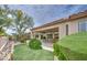 Beautiful backyard featuring manicured landscaping with artificial turf and covered patio with swing at 5289 S Red Yucca Ln, Gold Canyon, AZ 85118