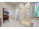 Spa-like bathroom featuring a glass shower, jacuzzi tub, and a view of the walk-in closet at 5289 S Red Yucca Ln, Gold Canyon, AZ 85118