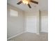 This bedroom features neutral walls, carpet, a closet and ceiling fan at 5289 S Red Yucca Ln, Gold Canyon, AZ 85118