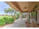 Inviting covered patio with seating and serene views of lush landscaping at 5289 S Red Yucca Ln, Gold Canyon, AZ 85118