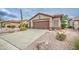 A two-car garage, desert landscaping, and neutral exterior define the home's curb appeal at 5289 S Red Yucca Ln, Gold Canyon, AZ 85118