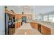 Well-lit kitchen with tile backsplash, black appliances, and center island at 5289 S Red Yucca Ln, Gold Canyon, AZ 85118